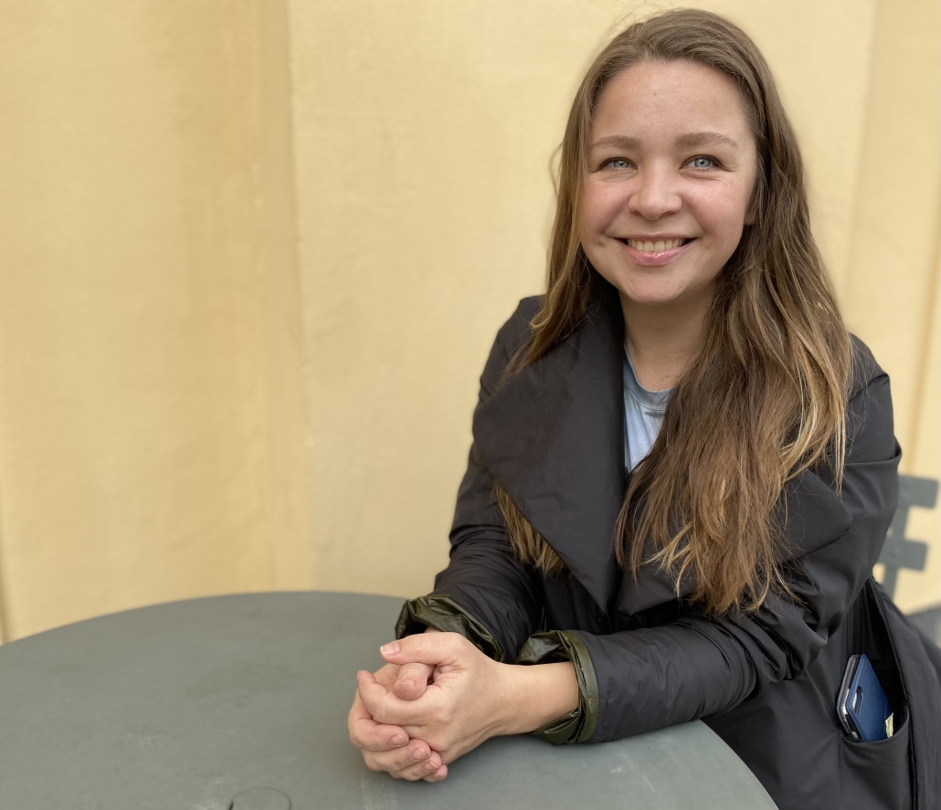 Tania Goryuschina, bilderboksillsutratör, sitter vid ett bord och ler.